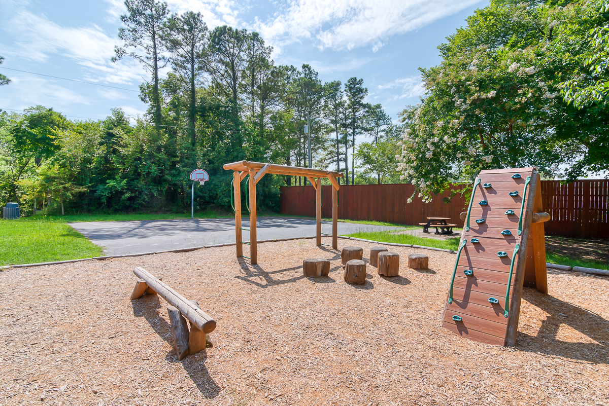 Sandy Run Park A small park with climbing equipment and a tree line